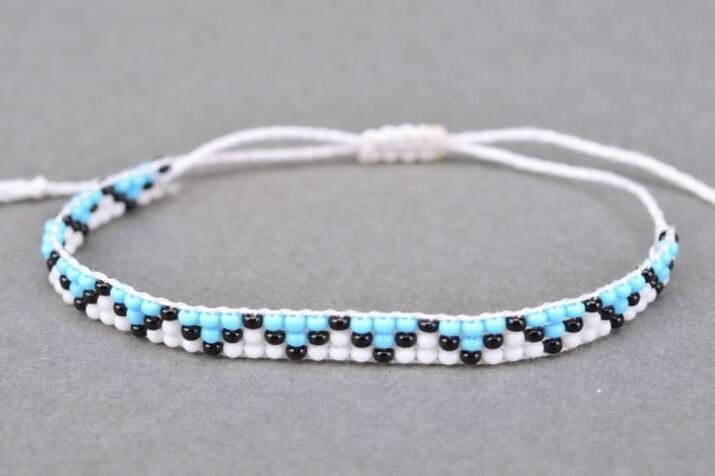 A bracelet made from threads and beads is an amulet that will bring good luck to the owner. 